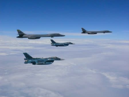 Two U.S. Air Force B-1B Lancer bombers fly from Andersen Air Force Base, Guam, for a 10-hour mission, with an escort of a pair of Japan Self-Defense Forces F-2 fighter jets in the vicinity of Kyushu, Japan August 8, 2017. U.S. Air Force/Handout via REUTERS