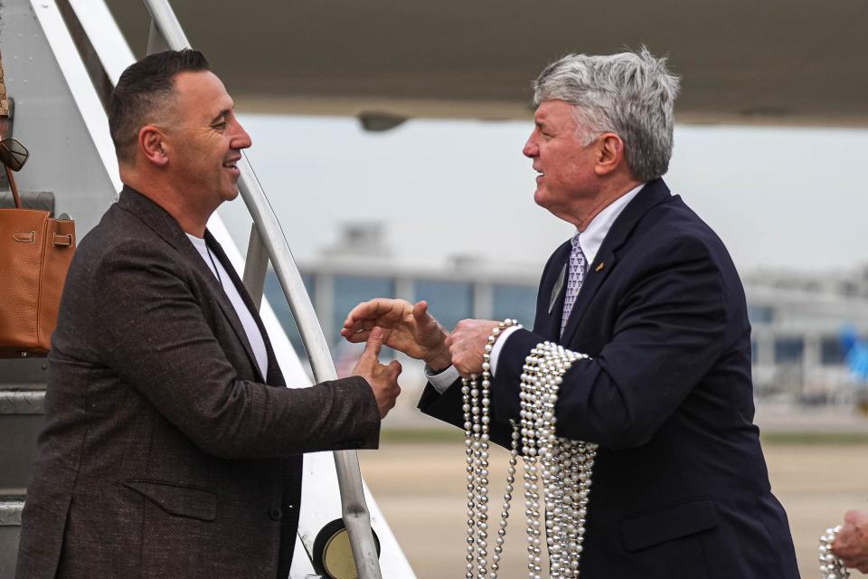 Sugar Bowl President Richard Briede, right, greets Texas head coach Steve Sarkisian at Louis Armstrong International Airport in New Orleans on Wednesday. The Longhorns have been preparing to face the Washington Huskies in the Sugar Bowl on Monday night.