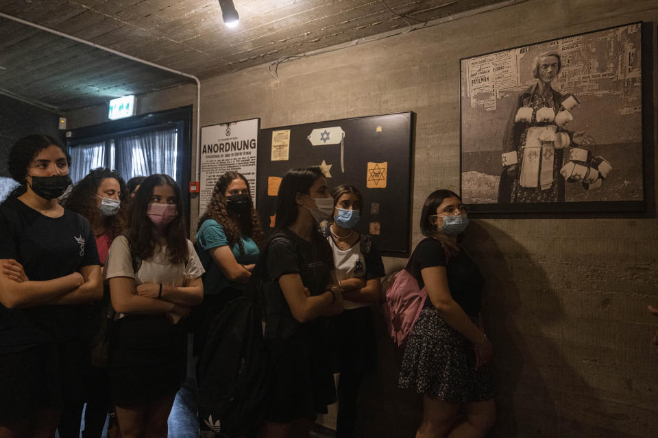 Israeli students visit at the museum "From Holocaust to Revival" on the eve of Holocaust Remembrance Day, in Kibbutz Yad Mordechai, Israel, Wednesday, April. 7, 2021. Holocaust remembrance day is one of the most solemn on Israel's calendar with restaurants and places of entertainment shut down, and radio and TV programming focused on Holocaust documentaries and interviews with survivors. (AP Photo/Tsafrir Abayov)