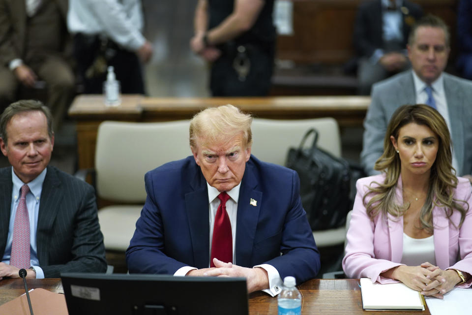 FILE - Former President Donald Trump, center, sits at the defense table with his attorney's Christopher Kise, left, and Alina Habba, at New York Supreme Court, Dec. 7, 2023, in New York. Testy encounters between lawyers for former President Donald Trump and judges have come to be expected as the attorneys carry into the courtroom the bombastic, and often antagonistic, style that defines his campaign trail demeanor. (AP Photo/Eduardo Munoz Alvarez, Pool, File)