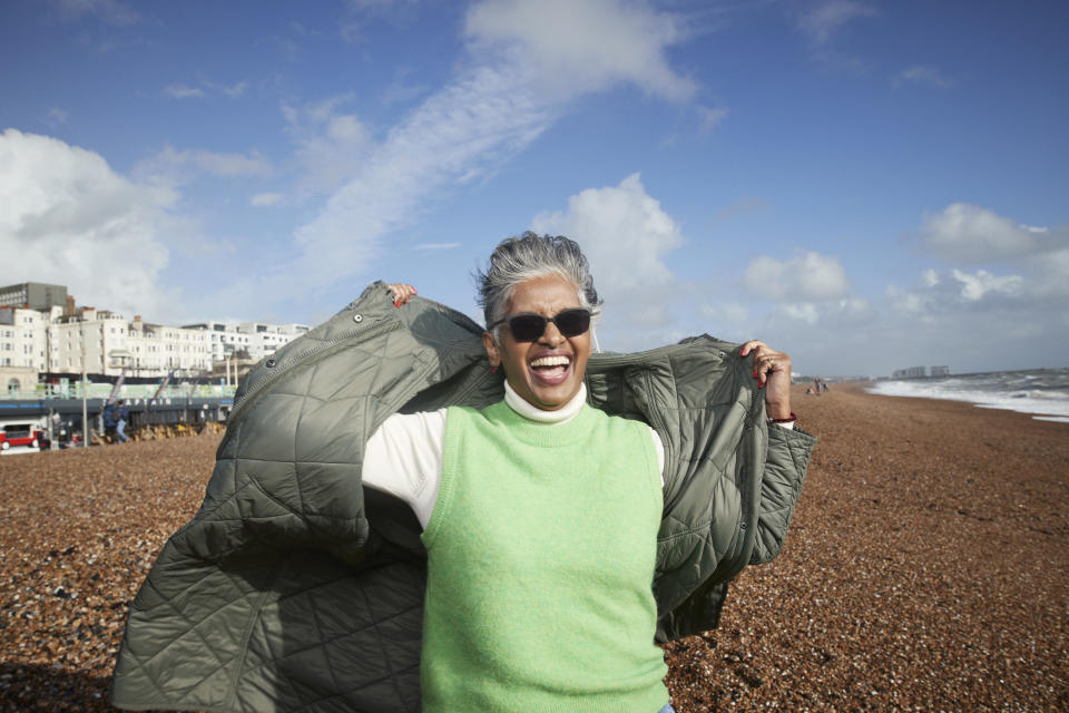 person with their coat blowing in the wind