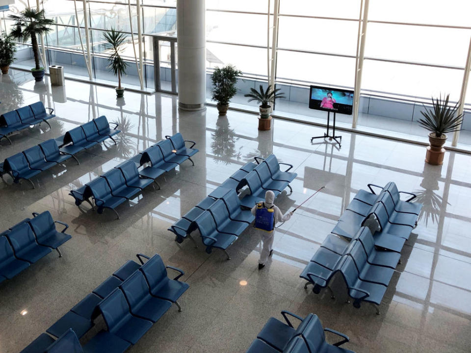 Pictured is an employee disinfecting public spaces at Pyongyang International Airport amid the coronavirus outbreak. 