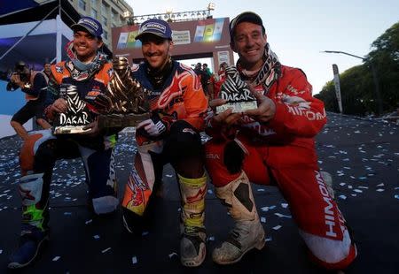 Dakar Rally - 2017 Paraguay-Bolivia-Argentina Dakar rally - 39th Dakar Edition - Twelveth stage from Rio Cuarto to Buenos Aires, Argentina 14/01/17. Sam Sunderland (C) of Britain, Matthias Walkner (L)of Austria and Gerard Farres Guell (R) of Spain pose with their trophy during the Dakar Rally 2017 podium ceremony. Sunderland was first, Walkner was second and Guell was third. REUTERS/Ricardo Moraes