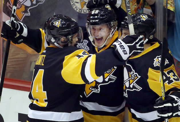 Pittsburgh Penguins’ Jake Guentzel, center, celebrates his goal against the Nashville Predators with Chris Kunitz, left, and Conor Sheary, right, during the first period in Game 2 of the NHL hockey Stanley Cup Final, Wednesday, May 31, 2017, in Pittsburgh. (AP Photo/Gene J. Puskar)