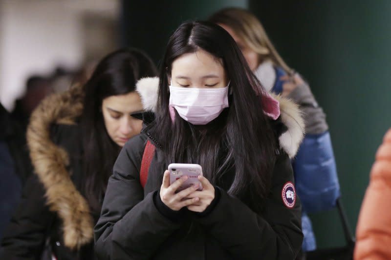 A woman wears a mask covering her mouth and nose while walking through the subway on January 27, 2020, in New York City, less than one week after the first reported case of coronavirus in the United States. File Photo by John Angelillo/UPI