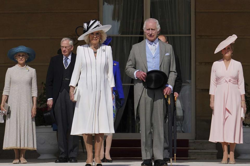 <p>Press Association via AP Images</p> (Center) Queen Camilla and King Charles at a Buckingham Palace garden party on May 8, 2024.
