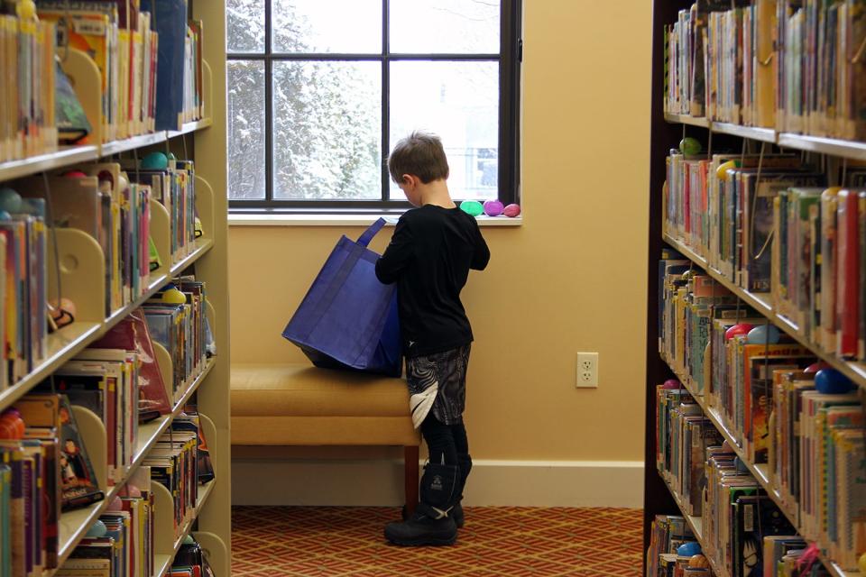 Hudson Szymanski, 7, looks for Easter eggs at the Petoskey District Library.