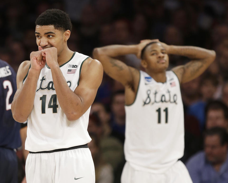 Michigan State's Gary Harris and Keith Appling react in the second half of a regional final against Connecticut at the NCAA college basketball tournament on Sunday, March 30, 2014, in New York. (AP Photo/Seth Wenig)