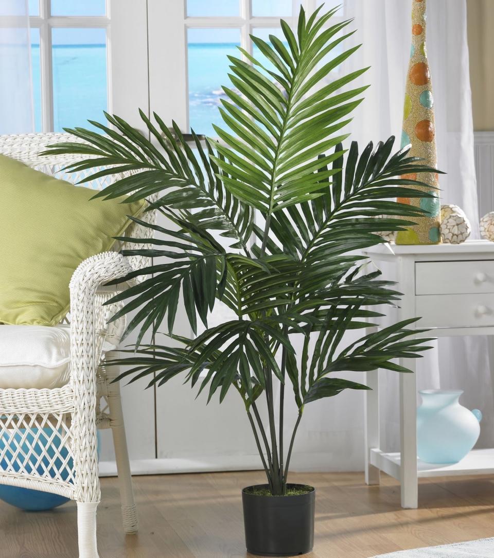 the artificial palm in a pot in a bedroom