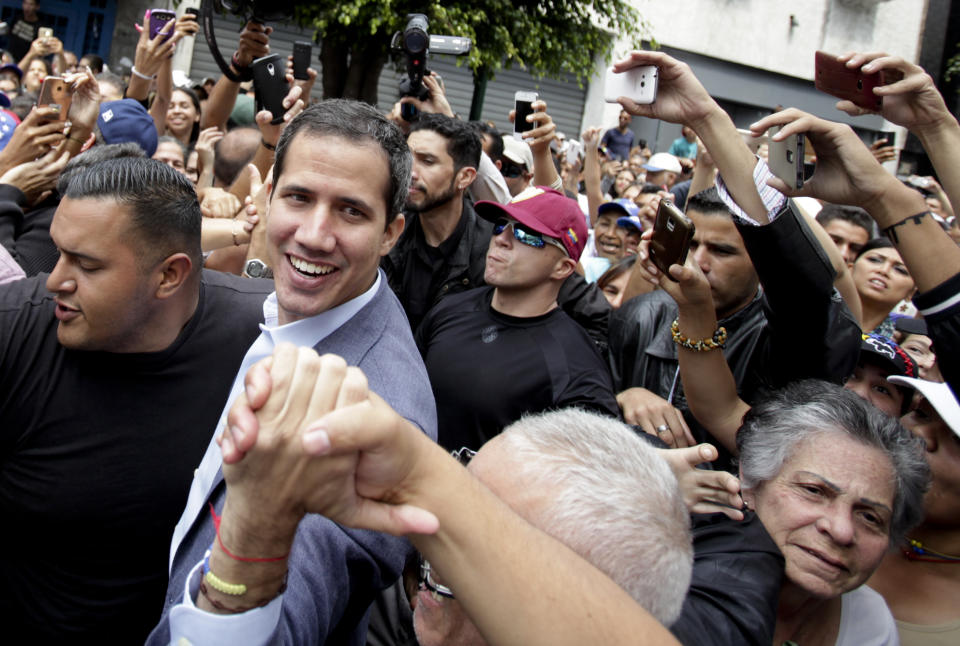 Venezuela's self-proclaimed interim president Juan Guaido greets supporters at a rally in Los Teques, Miranda State, Venezuela, Saturday, March 30, 2019. Guaido took his campaign for change to one of the country's most populous states on Saturday, while supporters of the man he is trying to oust, President Nicolas Maduro, held a rival demonstration in the capital after another nationwide blackout. (AP Photo/Boris Vergara)