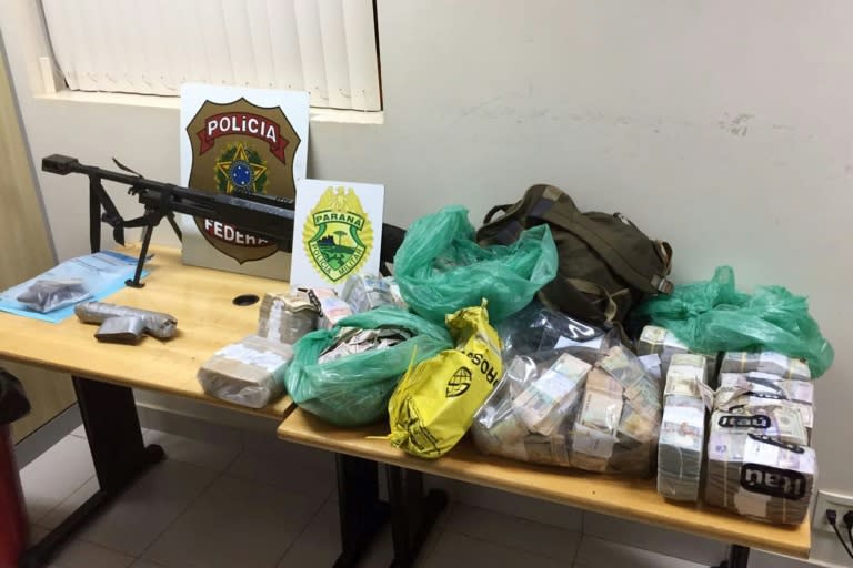 An assault rifle and money seized on April 24, 2017, after the robbery in Ciudad del Este, Brazil