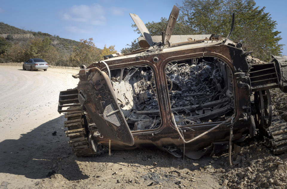 A destroyed Armenian APC is seen on the road from Stepanakert to Martekert during a military conflict in the separatist region of Nagorno-Karabakh, Thursday, Oct. 15, 2020. The conflict between Armenia and Azerbaijan is escalating, with both sides exchanging accusations and claims of attacks over the separatist territory of Nagorno-Karabakh.(AP Photo)