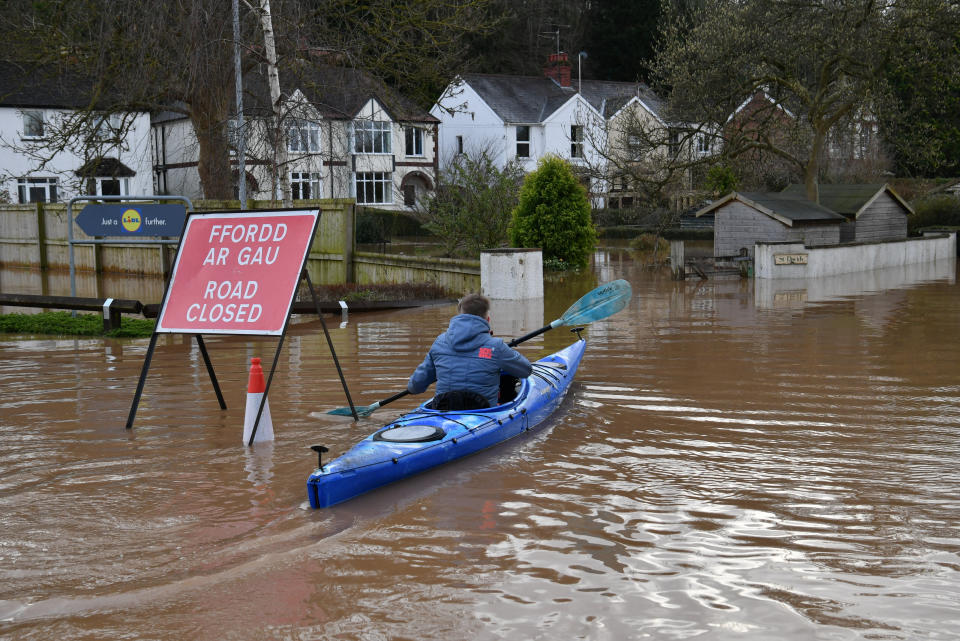 A canoeist makes his way down a road in Monmouth, in the aftermath of Storm Dennis. (Photo by Ben Birchall/PA Images via Getty Images)