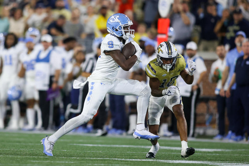 Oct 28, 2023; Atlanta, Georgia, USA; North Carolina Tar Heels wide receiver Devontez Walker (9) is tackled by Georgia Tech Yellow Jackets defensive back Ahmari Harvey (18) in the second half at Bobby Dodd Stadium at Hyundai Field. Mandatory Credit: Brett Davis-USA TODAY Sports