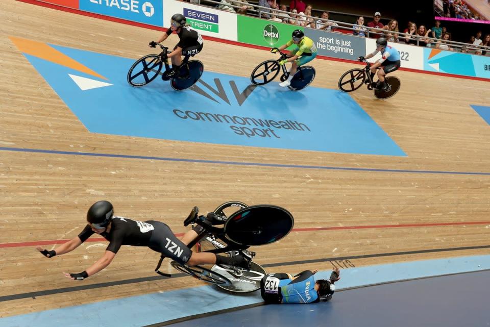 New Zealand's Bryony Botha fell over India's Meenakshi (AP) during the women's 10 km scratch race final