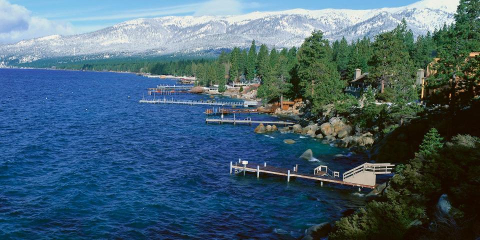 Boat docks surrounded by trees and blue water on the shores of Lake Tahoe