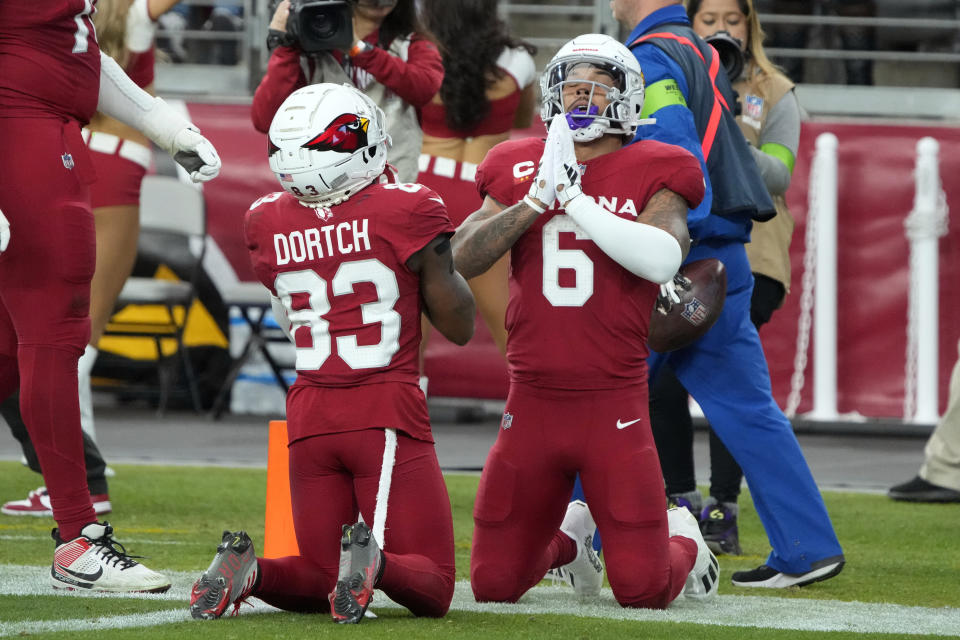 Arizona Cardinals running back James Conner (6) celebrates with Greg Dortch (83) after Conner scored a touchdown against the Seattle Seahawks in the second half of an NFL football game Sunday, Jan. 7, 2024, in Glendale, Ariz. (AP Photo/Rick Scuteri)