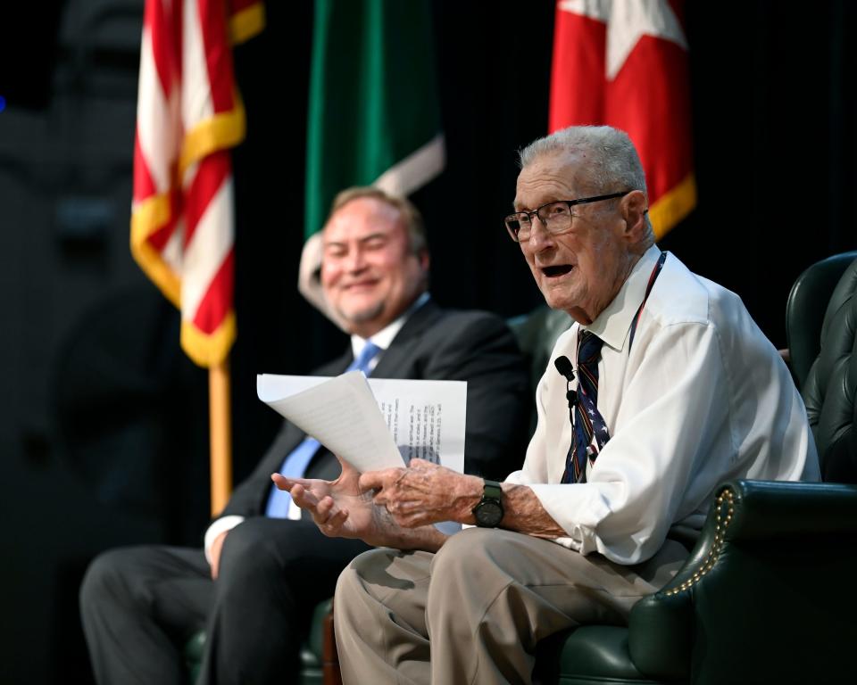 Retired Command Sgt. Maj. David Clark, far right, makes remarks during his retirement ceremony Friday, Aug. 26, 2022, at the John F. Kennedy Special Warfare Center and School auditorium, as retired Maj. Gen. Edward Reeder looks on.