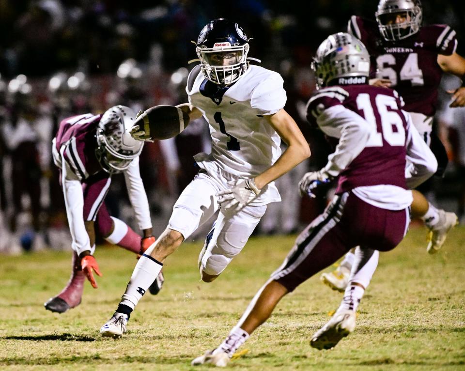 Redwood's Evan Galley runs against Mt. Whitney in the 67th annual Cowhide rivalry game Friday, October 28, 2022.