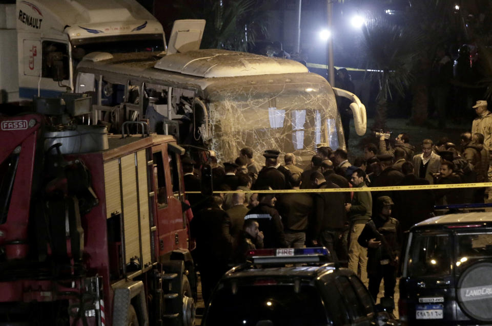 Security forces stand near a tourist bus after a roadside bomb in an area near the Giza Pyramids in Cairo, Egypt. Egypt's Interior Ministry said in a statement that two Vietnamese tourists were killed and others wounded, in the incident. (AP Photo/Nariman El-Mofty)