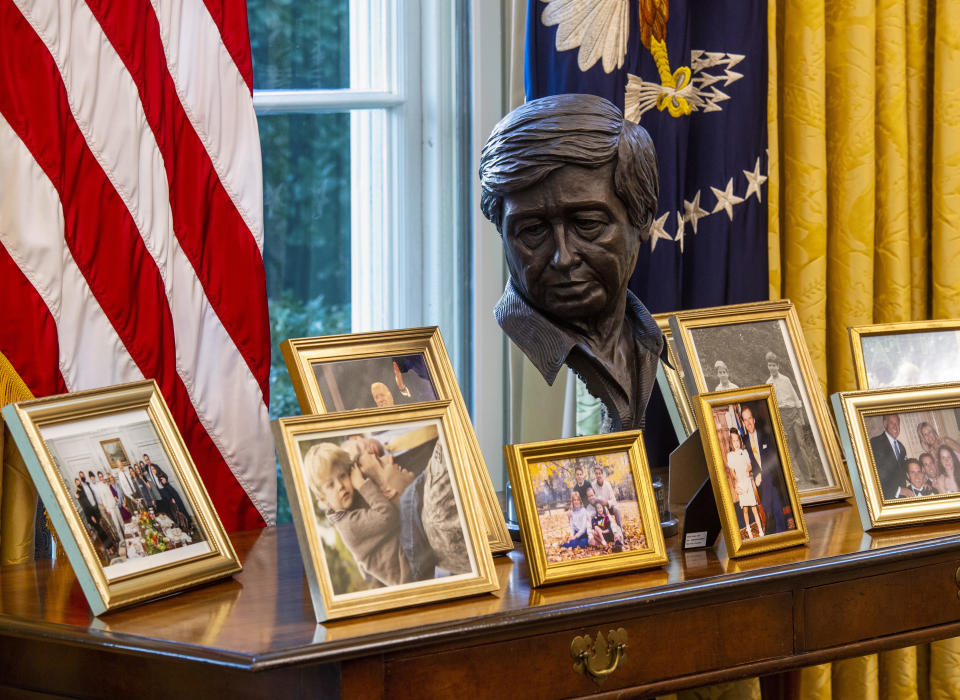 A sculpted bust of Cesar Chavez oversees a collection of personal framed photos on a table in the Oval Office awaiting President Joseph Biden at the White House in Washington, DC. / Credit: Bill O'Leary/The Washington Post via Getty Images