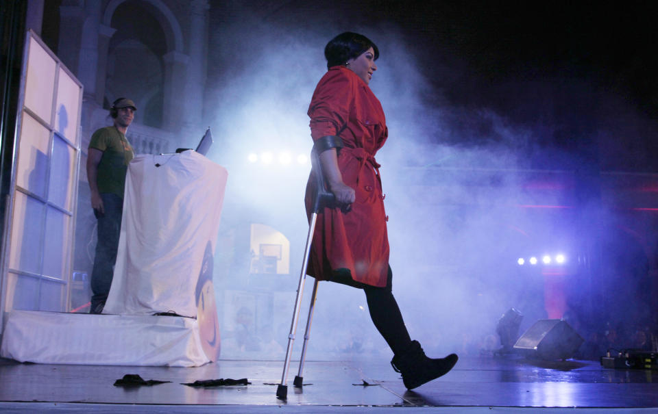 In this Feb. 5, 2013 photo, Helianny Garcia uses crutches as she parades down the catwalk during the Bionic Fashion show at the Metropolitan Cultural Center in Quito, Ecuador. Garc, a cancer survivor from Venezuela whose right leg was amputated due to the illness, joined 15 other models from Argentina, Brazil, Bolivia, Costa Rica, Colombia and Ecuador to model creations by Ecuadorian designers at an event organized by the Youth Against Cancer Foundation which aimed to break stereotypes and social barriers for the young cancer survivors. (AP Photo/Dolores Ochoa) Garcia