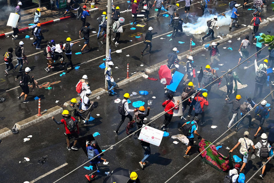 Image: Protesters run after tear gas was fired during a demonstration against the military coup in Yangon, Myanmar (AFP - Getty Images)