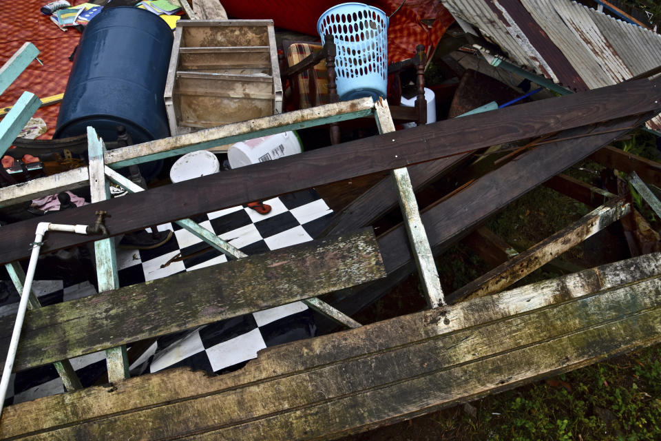 The wreck of a home damaged by a mudslide sits on a hillside after heavy rains poured down causing flooding and mudslides that damaged some homes and further battered areas already burdened by heavy ashfall from eruptions of La Soufriere volcano, in Kingstown, on the Caribbean island of St. Vincent, Thursday, April 29, 2021. (AP Photo/Orvil Samuel)