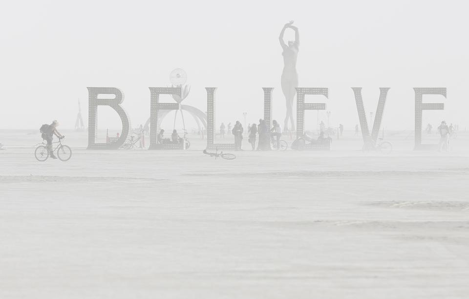 RNPS - PICTURES OF THE YEAR 2013 - Dust envelopes art installations during the Burning Man 2013 arts and music festival in the Black Rock Desert of Nevada, September 1, 2013. The federal government issued a permit for 68,000 people from all over the world to gather at the sold out festival, which is celebrating its 27th year, to spend a week in the remote desert cut off from much of the outside world to experience art, music and the unique community that develops. REUTERS/Jim Urquhart (UNITED STATES - Tags: SOCIETY TPX) FOR EDITORIAL USE ONLY. NOT FOR SALE FOR MARKETING OR ADVERTISING CAMPAIGNS. NO THIRD PARTY SALES. NOT FOR USE BY REUTERS THIRD PARTY DISTRIBUTORS. FOR USE WITH BURNING MAN RELATED REPORTING ONLY