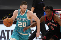 Charlotte Hornets forward Gordon Hayward (20) drives around Toronto Raptors forward Stanley Johnson (5) during the first half of an NBA basketball game Saturday, Jan. 16, 2021, in Tampa, Fla. (AP Photo/Chris O'Meara)