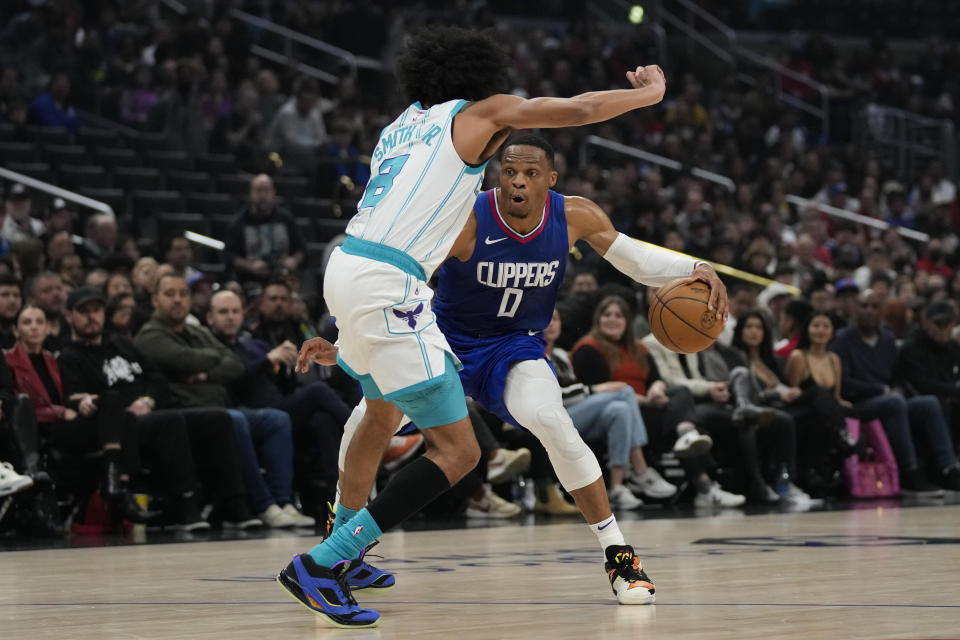 Charlotte Hornets guard Nick Smith Jr. (8) defends against Los Angeles Clippers guard Russell Westbrook (0) during the first half of an NBA basketball game in Los Angeles, Tuesday, Dec. 26, 2023. (AP Photo/Ashley Landis)