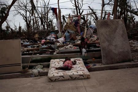 Two girls play amid the rubble after Hurricane Matthew in a street of Port-a-Piment, Haiti, October 9, 2016. REUTERS/Andres Martinez Casares