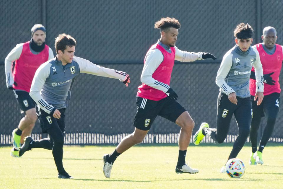 Crew forward Jacen Russell-Rowe dribbles between defender Will Sands (3) and midfielder Taha Habroune (16) during preseason training at the OhioHealth Performance Center.