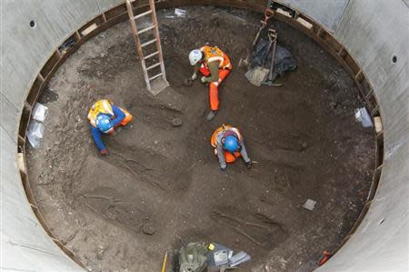 Archaeologists work on unearthed skeletons in the Farringdon area of London in this undated handout photograph released March 15, 2013. REUTERS/Crossrail/Handout
