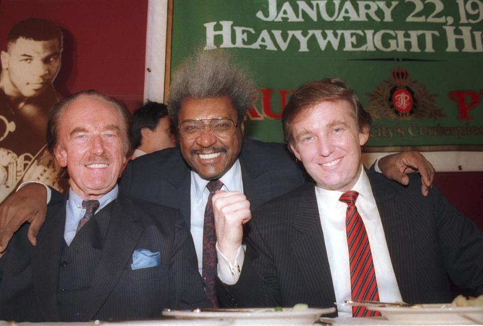FILE - In this December 1987 file photo, Donald Trump, right, pictured with his father, Fred Trump, left, and boxing promoter Don King participate in news conference in Atlantic City, N.J. Many of President-elect Donald Trump’s cultural touchstones, which he’d frequently namedrop at campaign rallies and on Twitter, including Don King, were at their peak in the 1980s, the decade that Trump’s celebrity in New York rose, Trump Tower was built, “The Art of the Deal” was published and he first flirted with running for public office. (AP Photo/File)