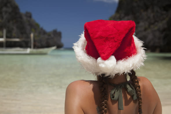 Mandatory Credit: Photo by Design Pics Inc/REX (3335313a) Model Released - A Woman Tourist Wears A Santa Hat And Bikini On Tropical Matinloc Island Near El Nido And Corong Corong Bacuit Archipelago On Palawan Philippines VARIOUS  