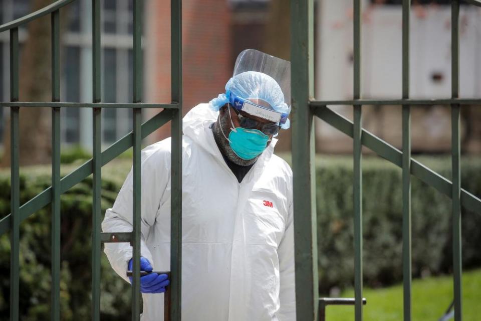 Healthcare workers prepare to transfer the body of a deceased person at a medical center in Brooklyn.