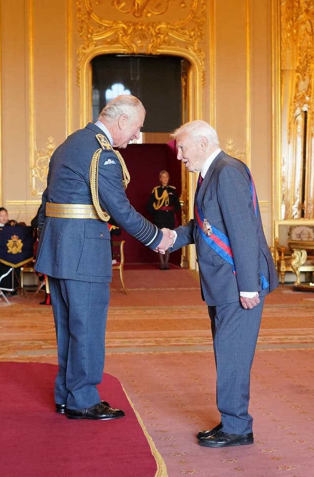 Sir David Attenborough is made a Knight Grand Cross of the Order of St Michael and St George by the Prince of Wales at Windsor Castle (Jonathan Brady/PA)