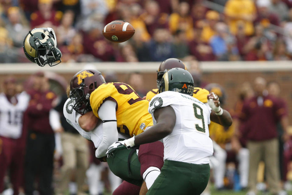 <p>Colorado State quarterback Collin Hill loses his helmet and football after being tackled by Minnesota defensive lineman Tai'yon Devers during an NCAA college football game, Sept. 24, 2016, in Minneapolis. (Photo: Stacy Bengs/AP)</p>