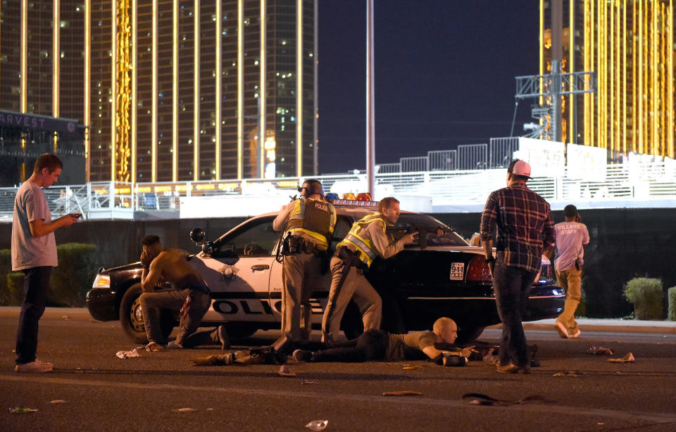 Las Vegas police search for the gunman while protecting fleeing fans.