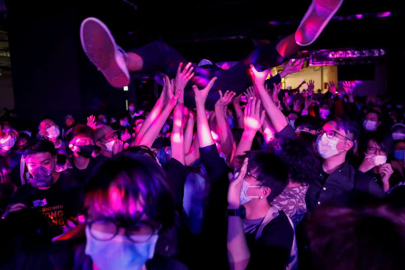 Fans wearing protective masks enjoy a band's performance at Hidden Agenda: This Town Needs (TNN) Live House during the club's last concert as business plummets due to the fear of the coronavirus, in Hong Kong