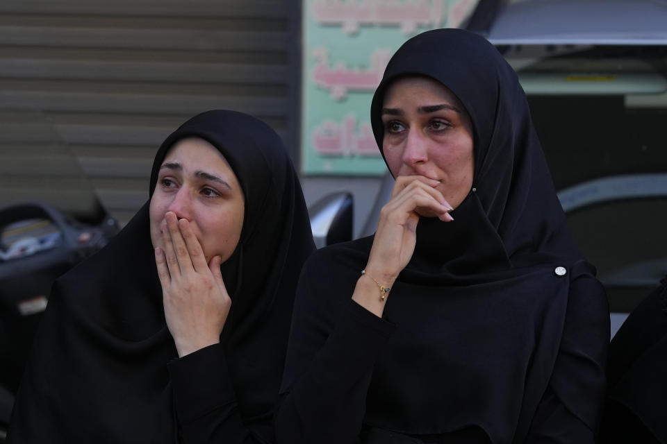 Women mourn during the funeral procession of Abbas Mohammed Raad, the son of the head of Hezbollah's parliamentary bloc, Mohammed Raad, who was killed by an Israeli strike, in the southern town of Jbaa, Lebanon, Thursday, Nov. 23, 2023. The militant Hezbollah group fired more than 50 rockets at military posts in northern Israel on Thursday, a day after an Israeli airstrike on a home in southern Lebanon killed five of the group's senior fighters. (AP Photo/Bilal Hussein)