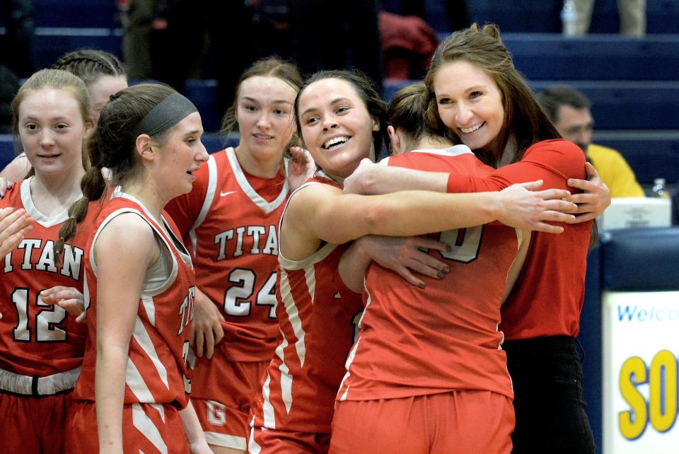 Glenwood's Head Coach Alyssa Riley hugs some of her players after their victory over Taylorville during the 3A Girls Basketball Regional Tournament Friday, February 16, 2024.