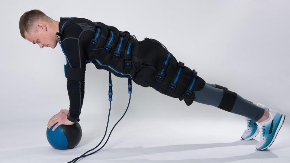 Un hombre vestido con un traje de electroestimulación muscular.