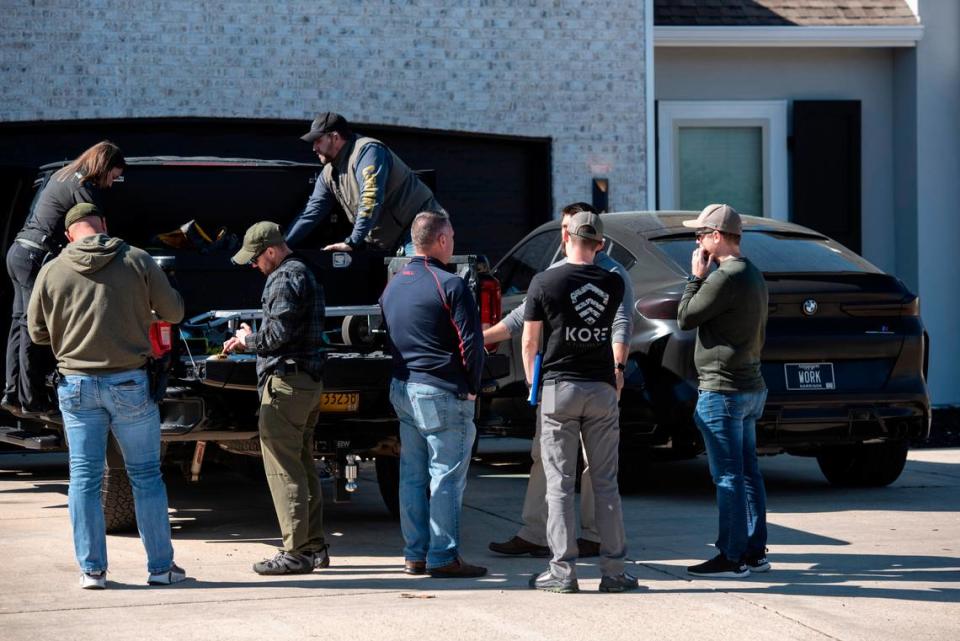 Drug Enforcement Administration agents and other law enforcement officers search two cars as a part of raids conducted on the home of Biloxi Councilman Robert Deming III on Thursday, Jan. 26, 2023. Agents would not say specifically what they were looking for or what they found, but agents also conducted raids on several locations of The Candy Shop & Kratom, a kratom store chain owned by Deming. Hannah Ruhoff