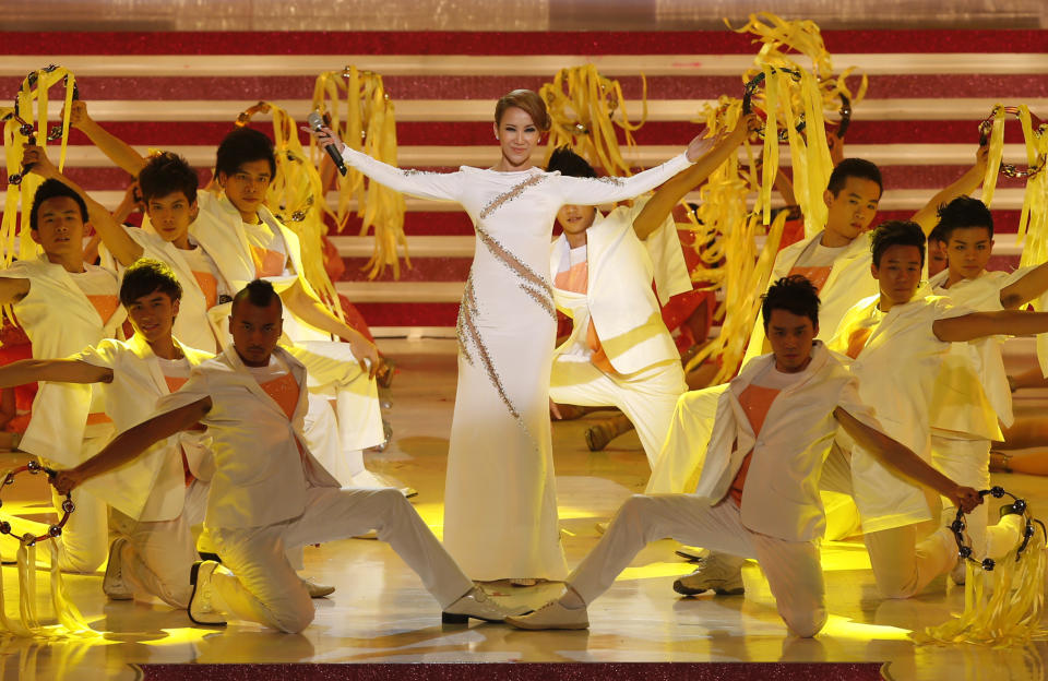 FILE - Hong Kong singer Coco Lee, center performs during the grand variety show as part of the ceremony on the 15th anniversary of the handover of Hong Kong, in Hong Kong Saturday, June 30, 2012. Coco Lee, a Hong Kong-born singer who had a highly successful career in Asia, died on Wednesday, July 5, 2023. She was 48. (AP Photo/Kin Cheung, File)