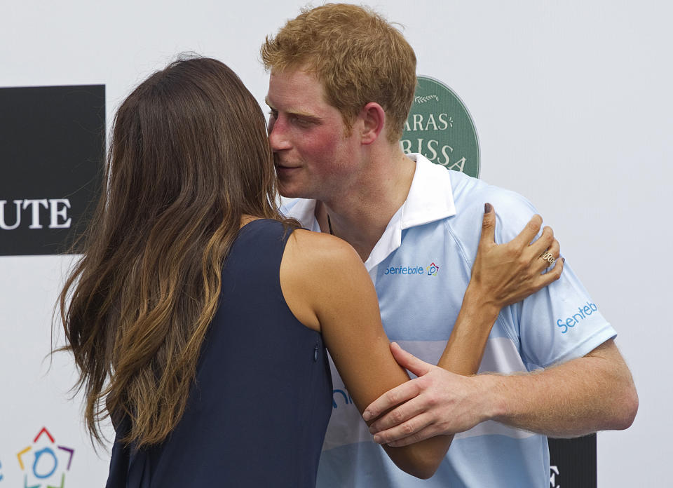 Britain's Prince Harry greets Brazilian model Fernanda Motta during an award ceremony after playing a charity polo match in Campinas, Brazil, Sunday March 11, 2012. Prince Harry is in Brazil at the request of the British government on a trip to promote ties and emphasize the transition from the upcoming 2012 London Games to the 2016 Olympics in Rio de Janeiro. (AP Photo/Andre Penner)