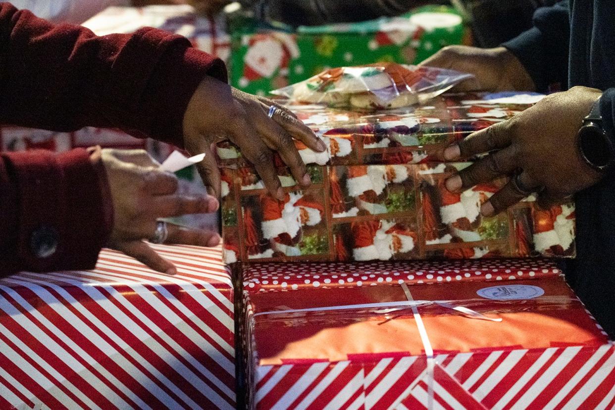 Volunteers organize gifts for Operation Christmas Present at Del Valle High School Thursday, Dec. 22, 2022. The Children's Wellness Center, run by the University of Texas School of Nursing, teamed up with New Covenant Church to provide around 300 presents to struggling families. 