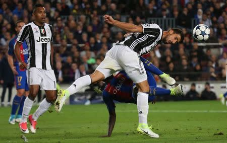 Football Soccer - FC Barcelona v Juventus - UEFA Champions League Quarter Final Second Leg - The Nou Camp, Barcelona, Spain - 19/4/17 Juventus' Sami Khedira heads clear of Barcelona's Samuel Umtiti Reuters / Sergio Perez Livepic