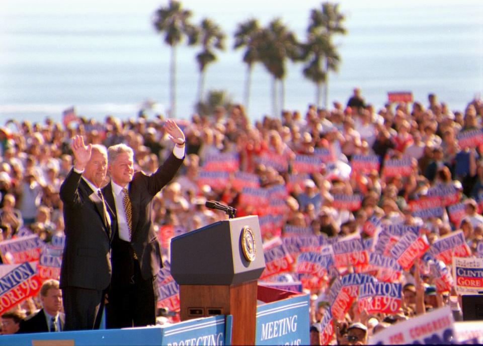 President Bill Clinton and Democratic congressional candidate Walter Capps wave to a sea of supporters